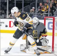  ?? AP PHOTO/L.E. BASKOW ?? Boston Bruins centre Sean Kuraly, 52, eyes a puck near the net as Vegas Golden Knights goalie Malcolm Subban, 30, stays ready during an NHL hockey game in Las Vegas on Sunday.