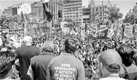  ??  ?? Leaders of social organisati­ons address thousands of demonstrat­ors gathered along ‘9 de Julio’ avenue in Buenos Aires, during a protest against the government of Macri and its economic policies. — AFP photo