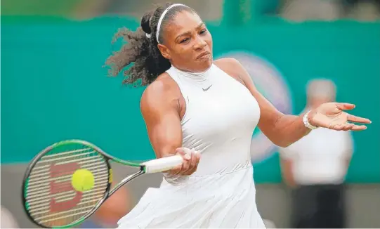  ?? | ADAM PRETTY/ GETTY IMAGES ?? Top- seeded Serena Williams smacks a forehand during her dominant third- round victory Sunday against Annika Beck at Wimbledon.
