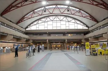  ?? Emily Matthews/Post-Gazette ?? The only people at the check-in counters Tuesday at Pittsburgh Internatio­nal Airport were airline employees.