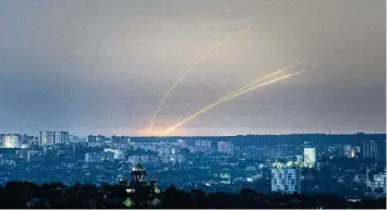  ?? EVGENIY MALOLETKA/ AP ?? Russian rockets are launched against Ukraine from Russia’s Belgorod region, seen from Kharkiv, Ukraine, on Thursday. Ukraine is desperatel­y seeking Patriot missile batteries from Western allies.