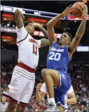  ?? TIMOTHY D. EASLEY — THE ASSOCIATED PRESS ?? Seton Hall forward Desi Rodriguez (20) goes up for a layup past the defense of Louisville forward Ray Spalding (13) during the first half of an NCAA college basketball game, Sunday in Louisville, Ky.