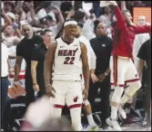  ?? Associated Press ?? Miami Heat forward Jimmy Butler (22) celebrates after scoring during the second half of Game 4 in a first-round NBA playoff series against the Milwaukee Bucks, Monday, in Miami. The Heat won 119-114.