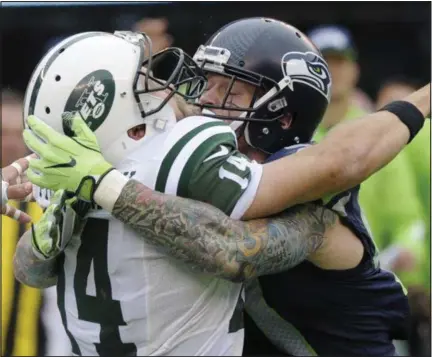  ?? PHOTOS BY BILL KOSTROUN — THE ASSOCIATED PRESS ?? Seattle Seahawks defensive end Cassius Marsh (91) hits New York Jets’ Ryan Fitzpatric­k (14) during the first half of an NFL football game Sunday in East Rutherford, N.J.
