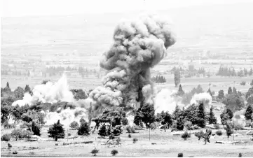  ??  ?? An explosion is pictured at Quneitra at the Syrian side of the Israeli Syrian border, as seen from the Israeli-occupied Golan Heights, Israel on Sunday. – Reuters photo