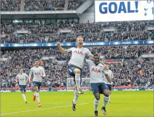  ?? AP PHOTO ?? Tottenham’s Harry Kane, centre, celebrates after scoring his side’s first goal during the English Premier League soccer match between Tottenham Hotspur and Liverpool at Wembley Stadium in London on Sunday.