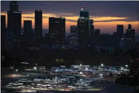  ?? JAE C. HONG / AP, FILE ?? On Jan. 27, 2021, motorists line up for COVID-19 vaccinatio­ns and testing in the parking lot of Dodger Stadium in Los Angeles.