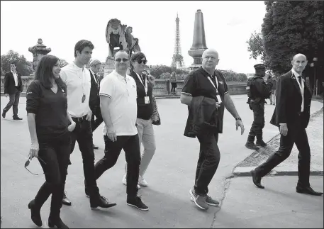  ?? The Associated Press ?? LOOKING AT PARIS: From the left, Paris mayor Anne Hidalgo, co-president of the Paris bid Tony Estanguet, president of the IOC Evaluation Commission for the 2024 Olympics Patrick Baumann walk on the bridge Alexandre III in Paris Monday. In background is...