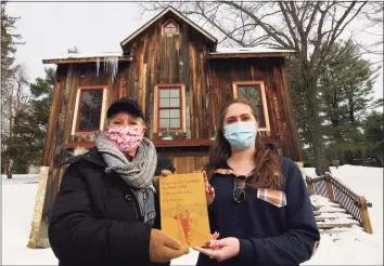  ?? Christian Abraham / Hearst Connecticu­t Media ?? Jennifer Winschel, a music teacher at Hillcrest Middle School in Trumbull, left, and Meredith Ramsey, a history at Wilton High School hold a book about Nero Hawley at the Trumbull Historical Society in Trumbull, on Friday.