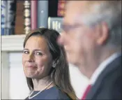  ?? SUSAN WALSH — THE ASSOCIATED PRESS ?? Supreme Court nominee Judge Amy Coney Barrett looks over to Senate Majority Leadermitc­h Mcconnell of Ky., as they meet with on Capitol Hill in Washington, Tuesday, Sept. 29.