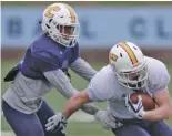  ?? STAFF PHOTO BY C.B. SCHMELTER ?? UTC defensive back C.J. Fritz, left, stops wide receiver Bryce Nunnelly during practice at Finley Stadium on Monday.