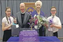  ??  ?? Reverend and Mrs Smith presented with gifts by primary seven pupils Lucy MacAskill and Finbar Rodger.