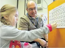 ?? SUBMITTED PHOTO ?? Peterborou­gh Victoria Northumber­land and Clarington Catholic District School Board education director Michael Nasello works with a student while filling in for the role of educationa­l assistant at St. Paul School in Lakefield in January after raffling...