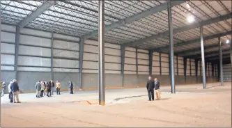  ?? File photo ?? Officials walk through the 100,000-square-foot industrial space built in Cedartown’s North Business Park in November 2014. The Developmen­t Authority of Polk County announced Tuesday that Oldcastle APG had purchased the building.