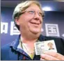  ?? SHI JIANXUE / FOR CHINA DAILY ?? Australian Anthony Terence Fitzpatric­k displays his new ID card in Hangzhou, Zhejiang province, on Friday.