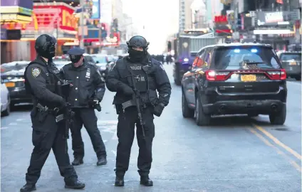  ?? Picture: Reuters ?? NYPD SHIELD. Police officers stand on a closed West 42nd Street near the New York Port Authority bus terminal after reports of an explosion in New York City yesterday.