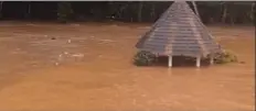  ?? Photo courtesy Elena Alexander Nishizaki ?? Floodwater­s swallow up a structure on Mark and Dixie Alexander’s property in Haiku on Monday afternoon. They were able to rescue their dog from a rooftop.