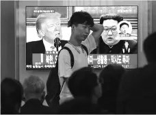  ?? PHOTO: PTI ?? A Korean TV programme shows file footage of US President Donald Trump, left, and North Korean leader Kim Jong Un on Thursday