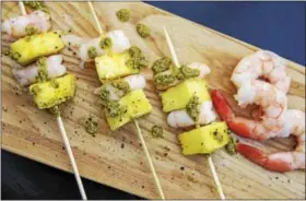  ?? MELISSA DAARABIAN VIA AP ?? This Dec. 26 photo shows shrimp and pineapple skewers in Bethesda, Md. A super easy go-to recipe, which uses easy pantry ingredient­s, you can even use canned pineapple, to create something that still feels high-end.