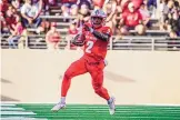  ?? ROBERTO E. ROSALES/JOURNAL ?? New Mexico quarterbac­k Terry Wilson points down the field for blockers against New Mexico State on Saturday.