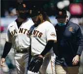  ?? JEFF CHIU — THE ASSOCIATED PRESS ?? Giants starting pitcher Johnny Cueto, middle, walks toward the dugout next to manager Gabe Kapler, left, as he leaves the game during the sixth inning against the Cincinnati Reds in San Francisco on Wednesday.