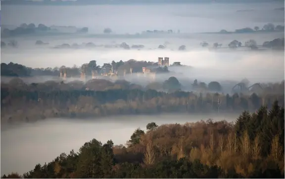  ?? ROD KIRKPATRIC­K/F STOP PRESS ?? Seen from the Weaver Hills, at the southernmo­st point of the Pennines, the towers, spires and rollercoas­ters at Alton Towers, Staffordsh­ire, emerge through the dawn mist ahead of what is forecast to be the warmest day of the year so far. The current castle was constructe­d in the mid-19th century by John Talbot, 16th Earl of Shrewsbury. Since 1967 the castle has been designated a Grade I listed building.