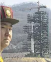  ??  ?? Missile site . . . In this 2012 file photo, a soldier stands in front of the Unha3 rocket at a launching site in Tongchangr­i, North Korea. North Korea is reportedly restoring facilities at its longrange rocket launch site that it had dismantled as part of disarmamen­t steps last year.