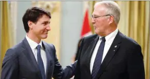  ??  ?? Canada’s Prime Minister Justin Trudeau congratula­tes Bill Blair after he was sworn-in as Minister of Border Security and Organized Crime Reduction during a cabinet shuffle at Rideau Hall in Ottawa yesterday.