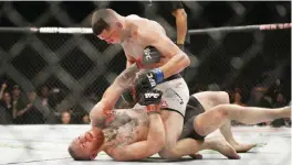  ??  ?? LAS VEGAS: In this March 5, 2016 file photo, Nate Diaz, top, trades punches Conor McGregor during their UFC 196 welterweig­ht mixed martial arts match, in Las Vegas. Diaz defeated McGregor. —AP