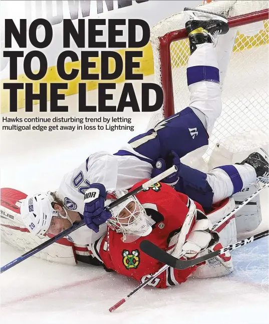  ?? JONATHAN DANIEL/GETTY IMAGES ?? Lightning forward Blake Coleman tumbles over Blackhawks goalie Kevin Lankinen after taking a shot Sunday at the United Center.