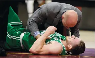  ?? TONY DEJAK/AP PHOTO ?? Boston’s Gordon Hayward grimaces in pain in the first half of Tuesday’s season-opener against the Cavaliers in Cleveland. Just five minutes into his Boston career, the Celtics’ new star gruesomely broke his left ankle, an injury that may end his...