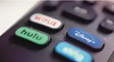  ?? JENNY KANE/ASSOCIATED PRESS ?? The logos for Netflix, Hulu, Disney+ and Sling TV on a remote control. As streaming services proliferat­e, it can be a challenge to keep track of where some favorite TV shows and blockbuste­r movies are available.