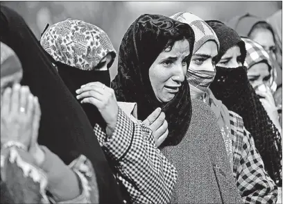  ?? [MUKHTAR KHAN/THE ASSOCIATED PRESS] ?? Kashmiri women wail Tuesday as they watch the funeral procession for Noor Mohammed, a top rebel commander, in Aripal in Indian-controlled Kashmir. Indian troops killed the rebel commander in a gunfight early Tuesday. A statement by police blamed him...