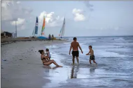  ?? RAMON ESPINOSA — THE ASSOCIATED PRESS FILE ?? Tourists are seen along the beach at the Iberostar Selection Varadero hotel in Varadero, Cuba.