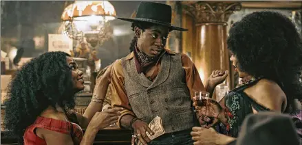  ?? DAVID LEE/NETFLIX ?? RJ Cyler (center) stars in “The Harder They Fall,” a new-school Western.