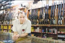  ?? ERIN SCHAFF / THE NEW YORK TIMES ?? Steve Clark, owner of Clark Brothers Gun Shop, attends the counter at his store in Warrenton, Va. Clark said his customers were drawn to newer and more modern rifles. “If the whole world went to ARS, that’s what I’d be selling,” Clark said. “It would...