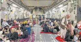  ?? SHAKIB RAHMANI/GETTY-AFP ?? Afghans inside a U.S. military aircraft wait to depart Thursday from the Kabul airport. Authoritie­s said Thursday that 6,741 people had been evacuated since Aug. 14, including 1,762 American citizens and Green Card holders.