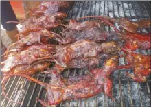  ?? J.P. SQUIRE/Special to The Okanagan Weekend ?? A G Adventures tour can include such unusual delicacies as deep-fried rat, above, water snake, tarantula legs, crickets and cocoons.