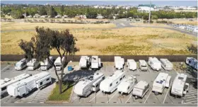  ?? Noah Berger / Special to The Chronicle ?? Recreation­al vehicles line a parking lot at the Santa Clara Valley Transporta­tion Authority Cerone bus yard in San Jose. The transit agency lets some employees with long commutes sleep overnight in the lot.