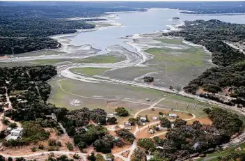  ?? Photos by Jerry Lara / Staff photograph­er ?? Grass grows on land exposed at Medina Lake on Monday. The lake, which is 30 miles west of San Antonio, is only 36.3 percent full as the region approaches the summer months.