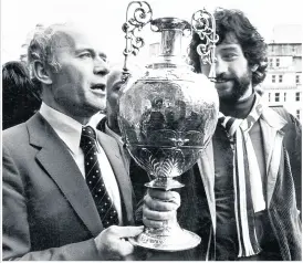  ??  ?? Ron Saunders with Dennis Mortimer and the league trophy, and with Ray Graydon with the League Cup in 1975. Centre, a banner unveiled on Sunday