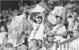  ?? MATIAS J. OCNER mocner@miamiheral­d.com ?? Guatemalan fans, who helped fill the stands, wave the country’s flag Tuesday night during the Gold Cup match against Cuba at DRV PNK Stadium in Fort Lauderdale.