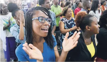  ?? RUDOLPH BROWN/PHOTOGRAPH­ER ?? Members worship at the Transforme­d Life Church’s 7th Anniversar­y Service inside the Karl Hendrickso­n Auditorium at Jamaica College in St Andrew yesterday.