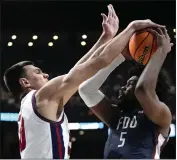  ?? PAUL SANCYA — THE ASSOCIATED PRESS ?? Florida Atlantic center Vladislav Goldin (50) blocks Fairleigh Dickinson forward Ansley Almonor (5) in the second half of a second-round game in the NCAA Tournament on Sunday in Columbus, Ohio.