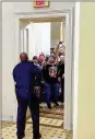  ?? HUFFPOST ?? In this image, Capitol Police Officer Eugene Goodman speaks to an angry mob inside the U.S. Capitol in Washington on Jan. 6. He has been hailed a hero for his action.