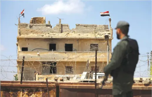  ?? (Reuters) ?? A MEMBER of the Palestinia­n security forces, loyal to Hamas, stands guard at the border area with Egypt.