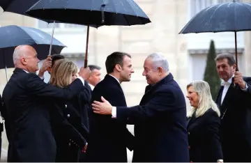  ??  ?? French President Emmanuel Macron and his wife Brigitte Macron welcome Netanyahu and his wife Sara at the Elysee Palace as part of the commemorat­ion ceremony for Armistice Day in Paris, France. — Reuters photo