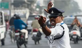  ?? — AFP ?? Smooth operator: Ranjeet moonwalkin­g as he directs traffic at a busy intersecti­on in Indore. His dance moves have made him a social media phenomenon with nearly 50,000 followers on Facebook.