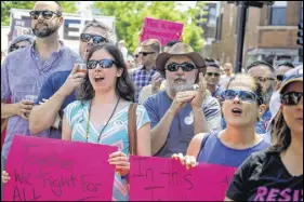  ?? AP photo ?? People attend the LGBTQ Chicago Equality rally in the Andersonvi­lle neighbourh­ood of Chicago. Starting in January, Illinois is outlawing a rare criminal defence argument allowing the use of a victim’s sexual orientatio­n as justificat­ion for violent...
