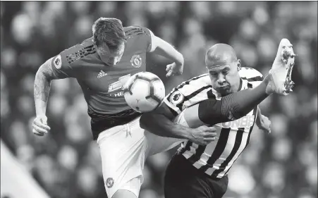  ?? SCOTT HEPPELL / REUTERS ?? Manchester United’s Phil Jones (left) and Newcastle United’s Salomon Rondon contest a high ball during Wednesday’s English Premier League match at St James’ Park, Newcastle. Goals by Romelu Lukaku and Marcus Rashford saw the visitor win 2-0.